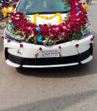 Wedding car décor with ribbons and floral garlands