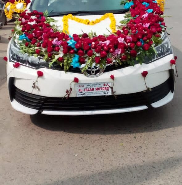 Wedding car décor with ribbons and floral garlands